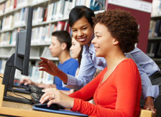 teacher and pupils working on computers